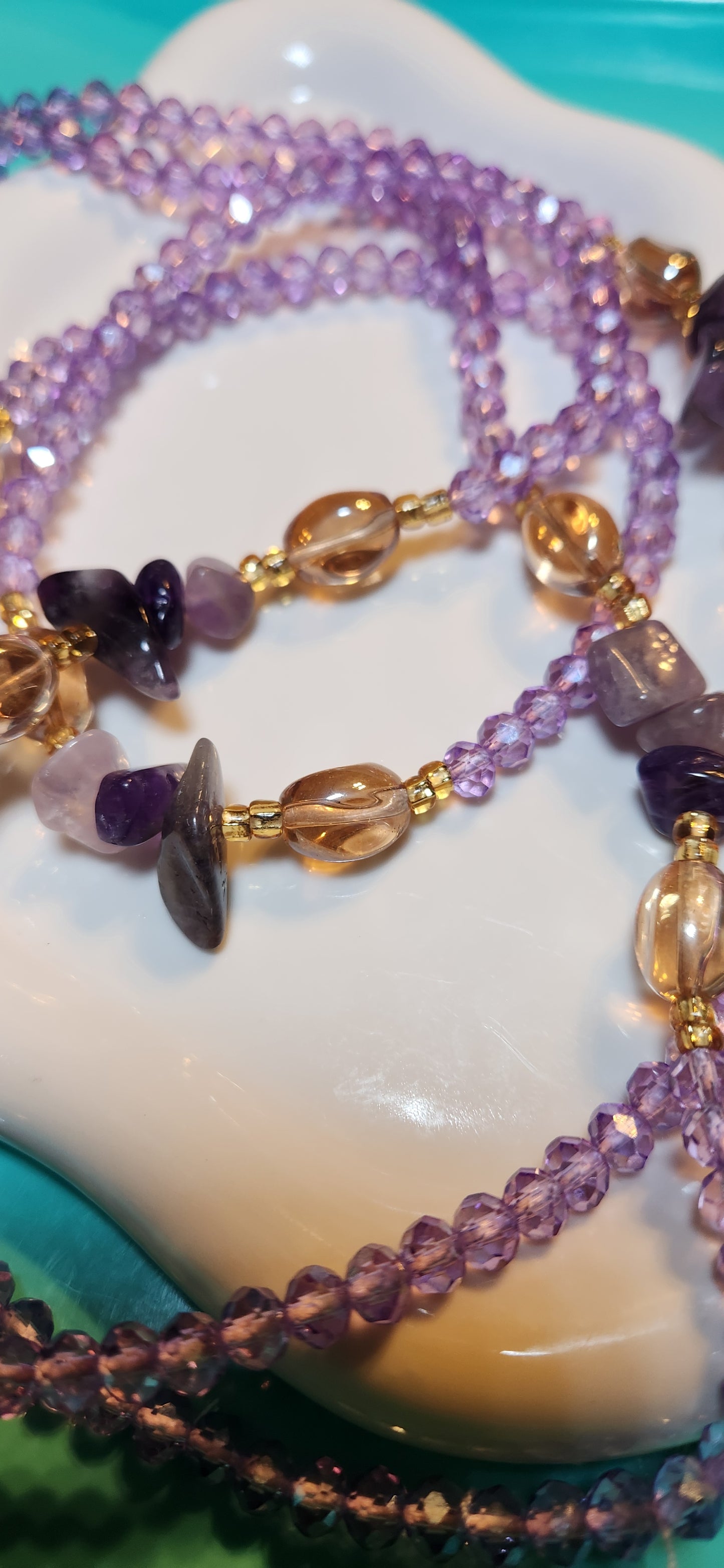 Sunstone Serenity is her name is it purple, : Incorporates the warm, translucent beads and a calming feel.