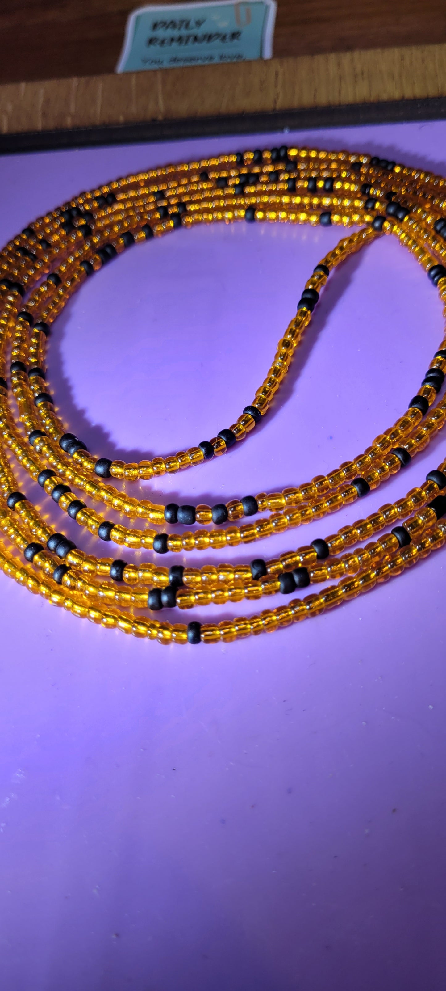 Orange and black traditional tie on body adornment.