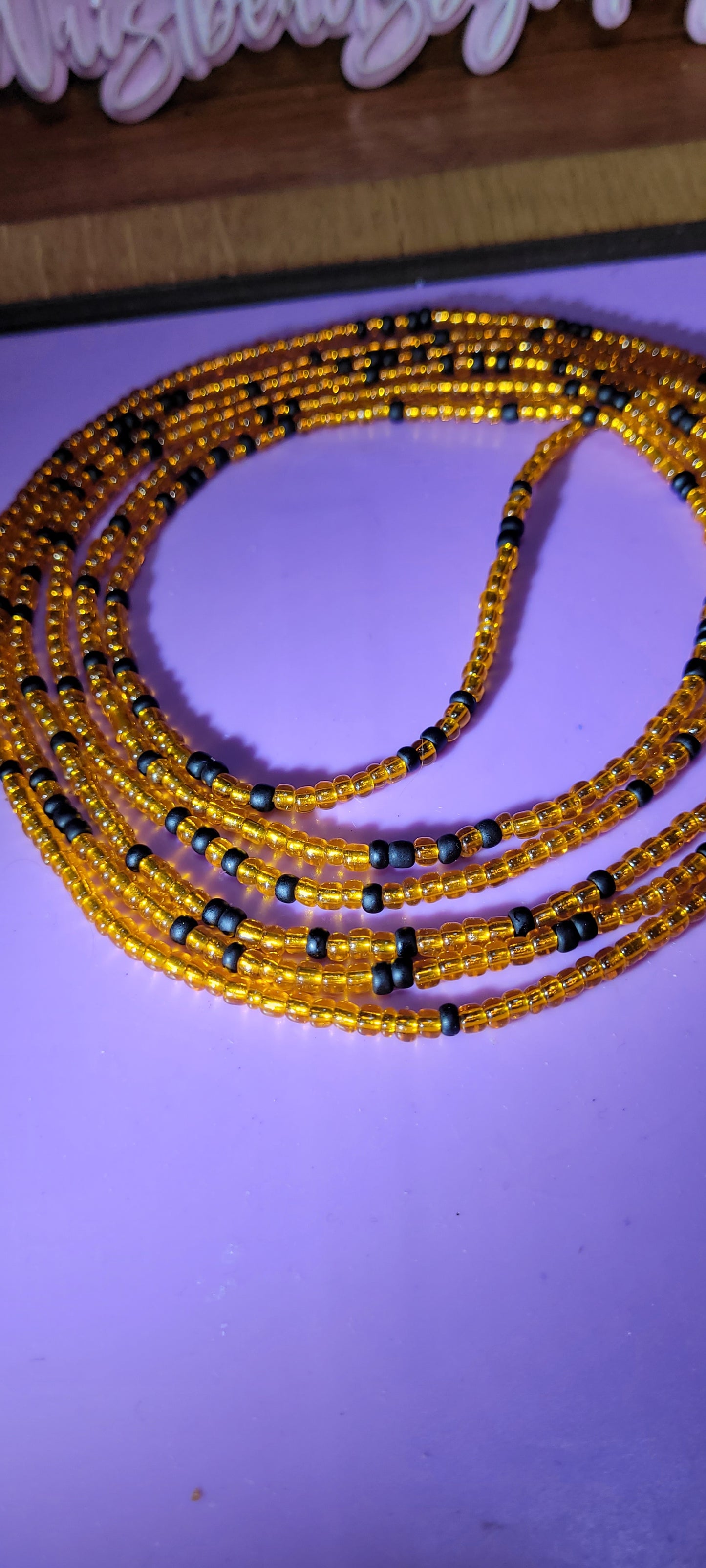 Orange and black traditional tie on body adornment.