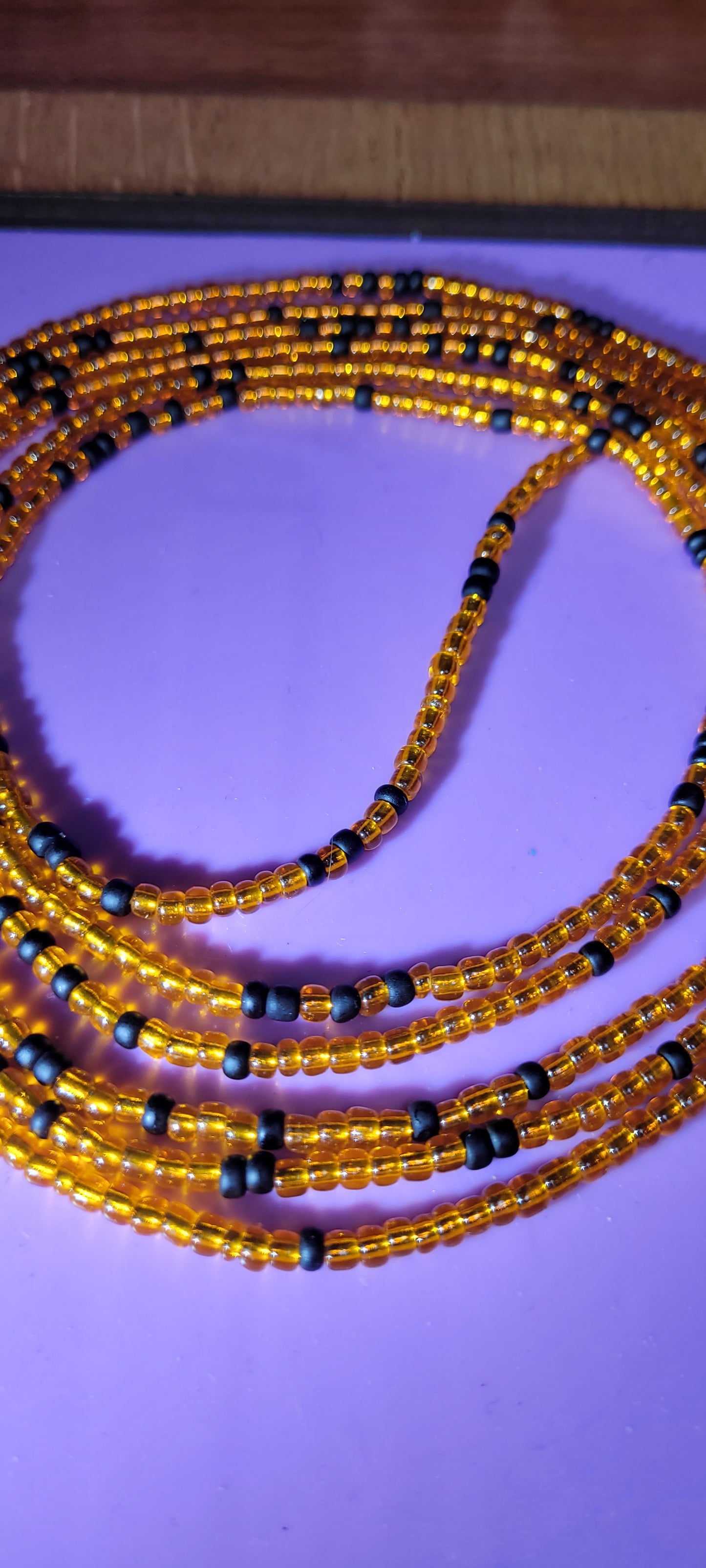 Orange and black traditional tie on body adornment.
